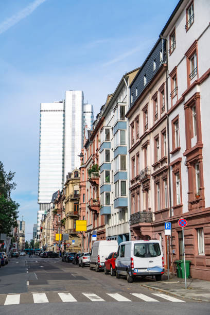 istock Old houses on background of modern blue skyscraper 1230195454