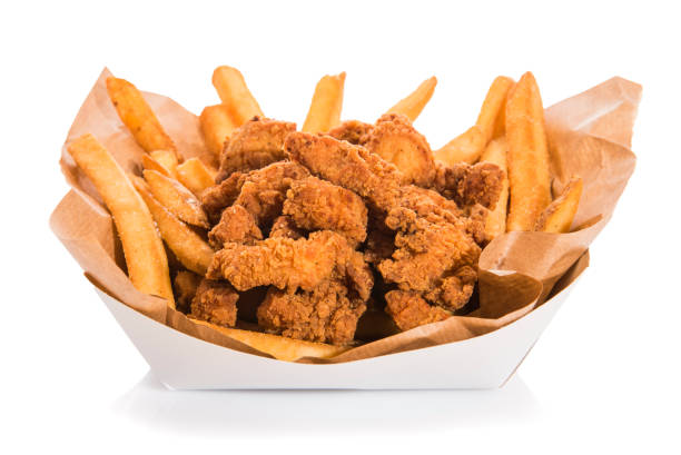 istock French fries with salt and chicken nuggets isolated on white. 1230203583