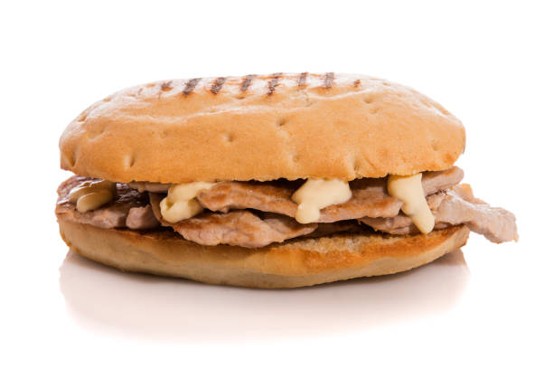istock Pork loin sandwich with mayonnaise isolated on white. 1230203585
