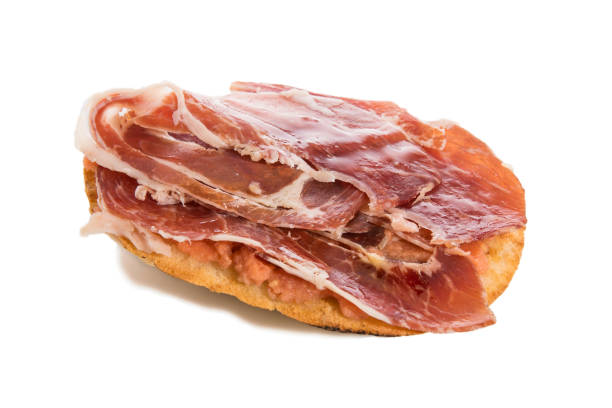 istock Mollete with Iberian ham and tomato, typical spanish food, isolated on white. 1230203651