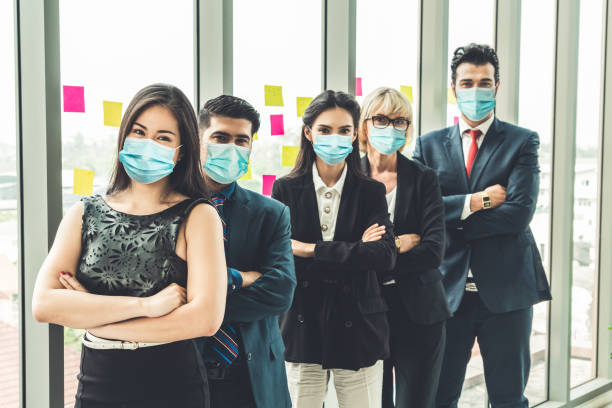 istock Confident business people with face mask protect from Coronavirus or COVID-19. 1230206626
