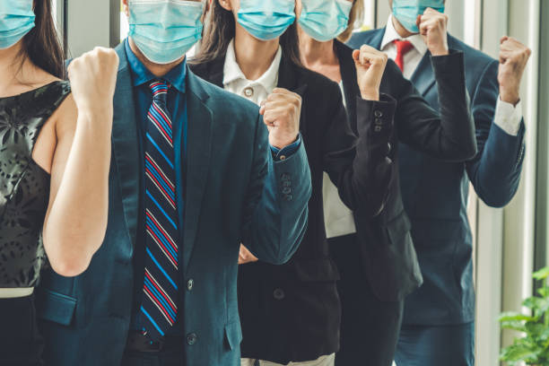istock Confident business people with face mask protect from Coronavirus or COVID-19. 1230207102