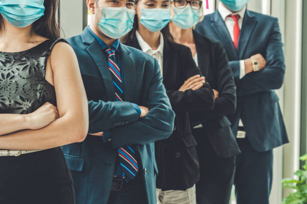 istock Confident business people with face mask protect from Coronavirus or COVID-19. 1230207132