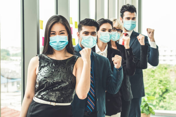 Confident business people with face mask protect from Coronavirus or COVID-19.