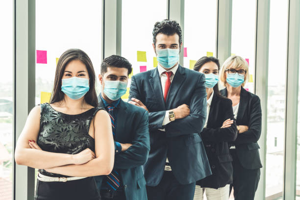 istock Confident business people with face mask protect from Coronavirus or COVID-19. 1230208209