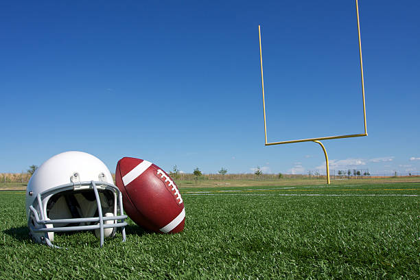 Football and Helmet on the Field stock photo