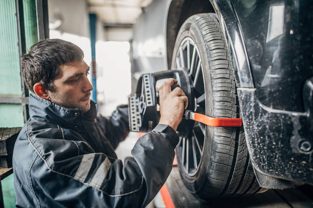 istock Man sets the wheel alignment equipment on a car wheel 1230211698
