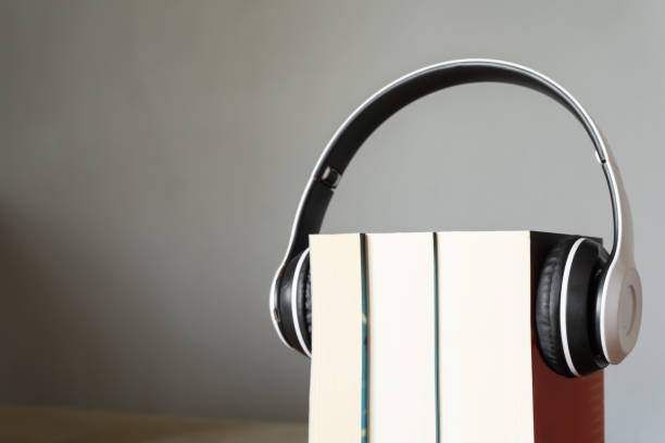 istock Books with headphone. Audio book concept. 1230250013