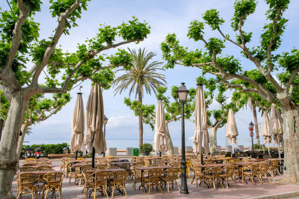 istock Empty tables on the terrace of a summer cafe 1230259758