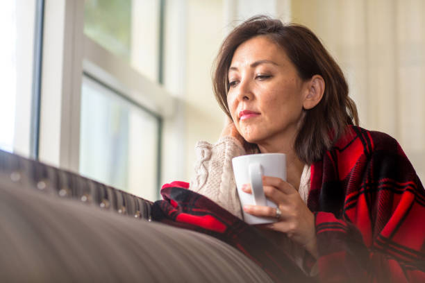 istock Mature woman feeling sad looking out a window. 1230266932