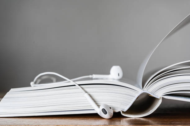 istock Books with headphone. Audio book concept. 1230297714