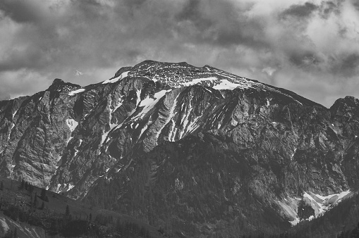 A dramatic view to black and white mountain and sky.