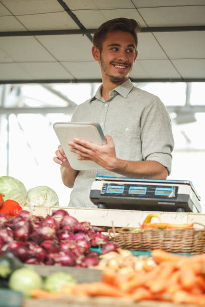 istock Technology serving a marketplace shopkeeper 1230384059