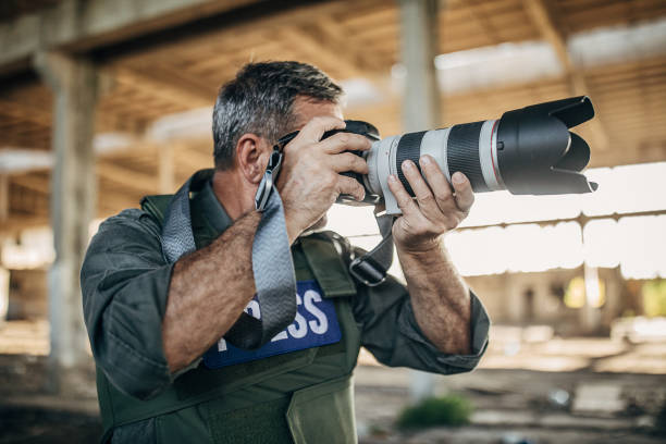 istock War reporter photographing with camera in abandoned building 1230395300