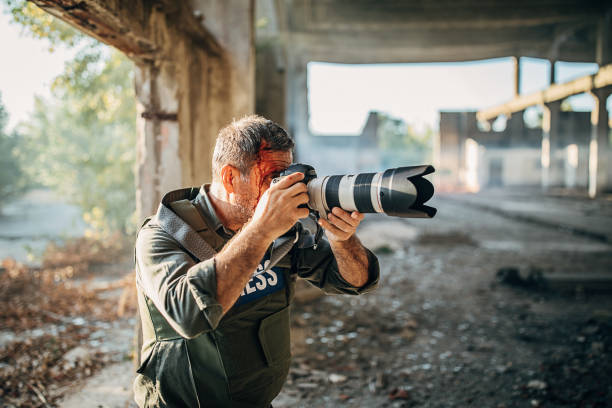 istock Wounded man war photographer in abandoned building 1230404055
