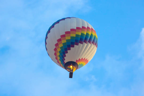 istock colored balloon with people flying in the sky in Cappadocia 1230459685
