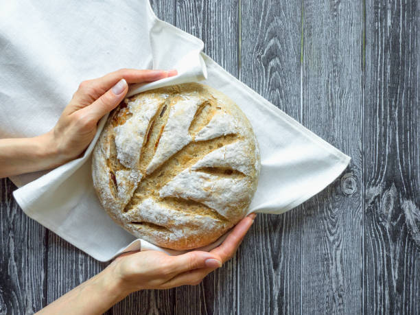 istock No knead baked bread in a hand 1230470614