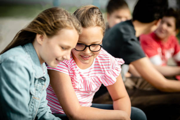 istock Teenagers using phone on the street 1230480070