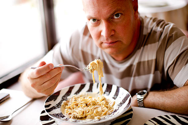 istock Serious Mature man eating pasta 123050806
