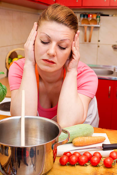 istock Depressed and sad young woman in kitchen 123051273