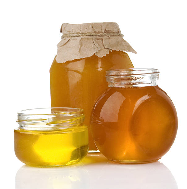 istock pot of honey and jar isolated on white 123056007