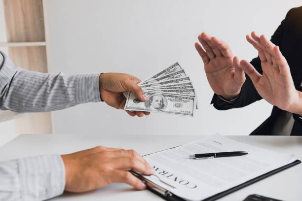 istock Business person refusing bribe given money by partner with anti bribery corruption concept. 1230573776