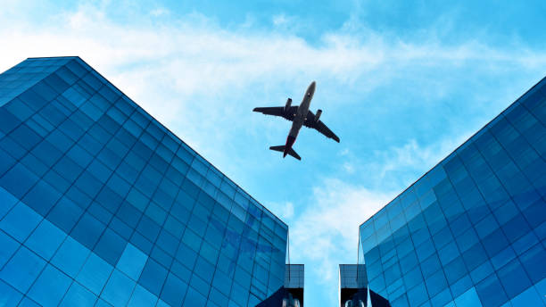 istock airplane in the blue sky with clouds 1230611306