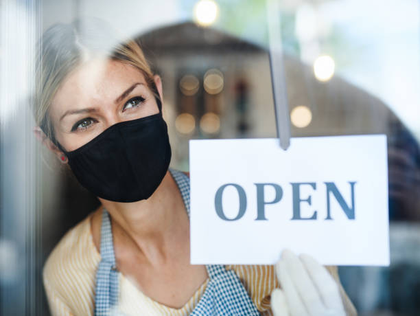 istock Coffee shop man owner with face mask, open after lockdown quarantine. 1230619406
