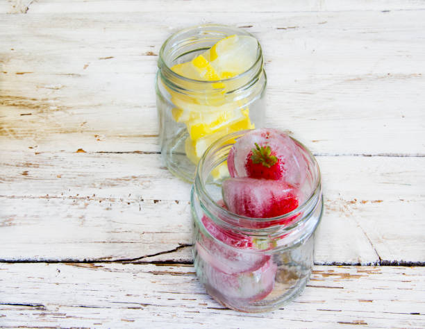 istock Ice cubes with lemons and frozen strawberries 1230626636