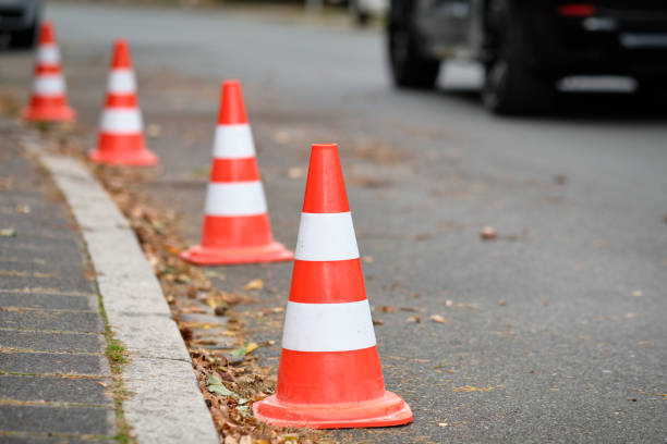 A row of traffic cones standing on a street stock photo