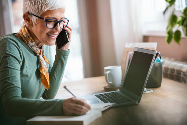 istock Mature woman working indoors at home 1230660164