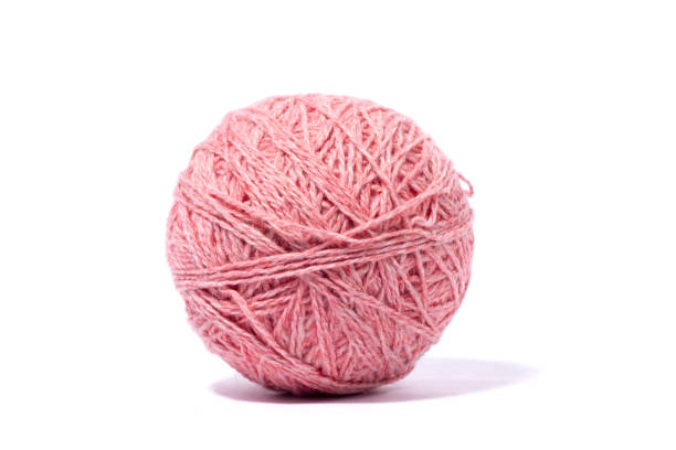 istock ball of woolen pink thread isolated on white background. 1230692327
