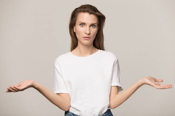istock Unsure woman shrugging shoulders, feeling confused, looking at camera 1230695617