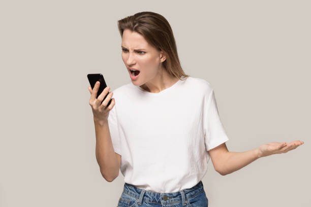istock Angry woman screaming at phone, problem with broken cellphone 1230695918