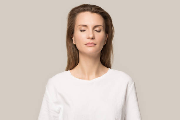 istock Calm mindful woman with closed eyes breathing deep, no stress 1230695920