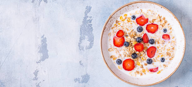 istock Healthy breakfast, bowl with oat granola, milk and berries 1230703595