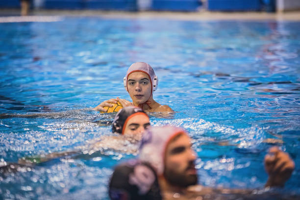 istock Young men playing a water polo 1230718532