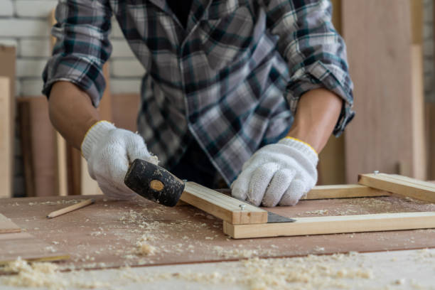 istock Carpenter working on wood craft at workshop to produce construction material or wooden furniture. The young Asian carpenter use professional tools for crafting. DIY maker and carpentry work concept. 1230732392