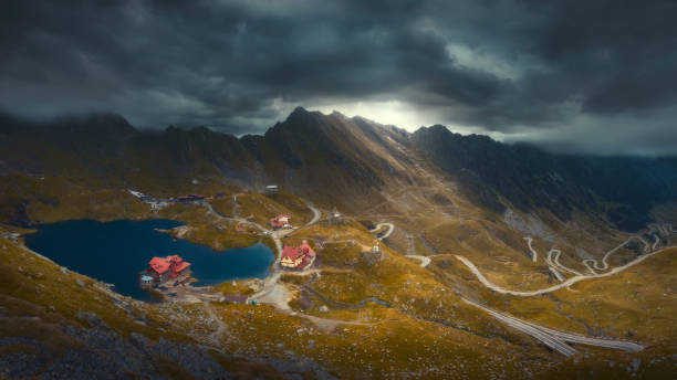 Transfagarasan highway in Romania with Balea lake Landscape image of iconic Transfagarasan paved road which crossing mountain range at 2034 meters altitude at overcast day. balea lake romania stock pictures, royalty-free photos & images