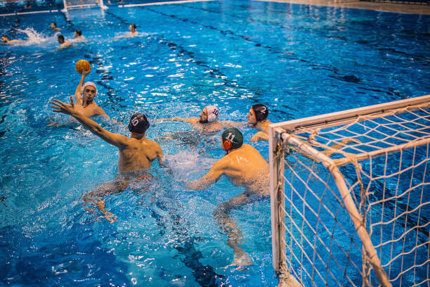 istock Men playing a water polo indoors 1230763584