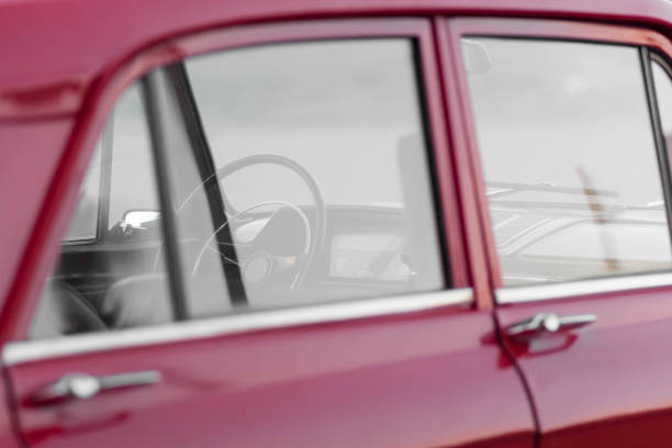 istock Interior of a red retro car. Transparent windows, thin steering wheel. 1230764095