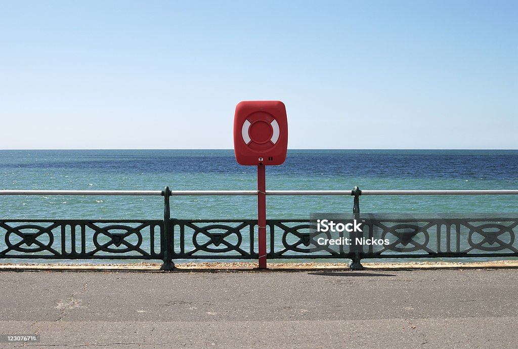 Lifejacket on seafront promenade. Brighton. UK Lifejacket (lifesaver) on railings at seafront promenade. Hove. Brighton. East Sussex. England Brighton - England Stock Photo