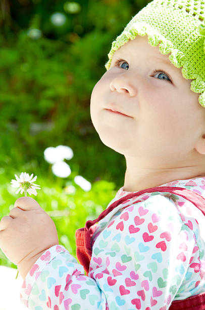 istock Baby-girl with flower 123076858