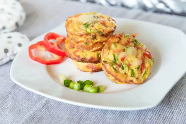 Photo of Fresh egg omelet muffins on the white dish. Ideas for healthy breakfast. Morning food.