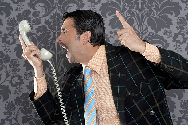 istock Angry nerd businessman retro telephone call shouting 123078343