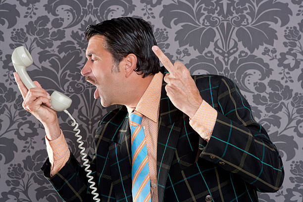 istock Angry nerd businessman retro telephone call shouting 123079677