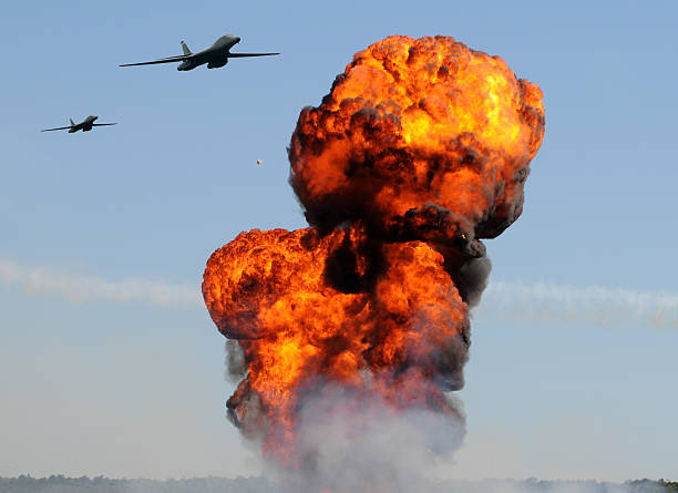 istock Two airplanes flying towards an explosion in a blue sky 123081392