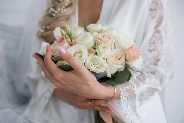 istock bride in a wedding dress with a bouquet 1230815360