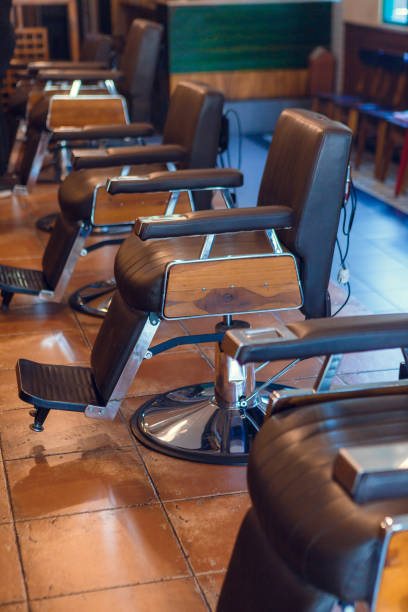 istock Empty chairs in retro styled barbershop. Hair salon interior. 1230832747
