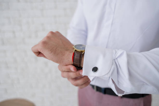 istock man puts a watch on his hand 1230867650